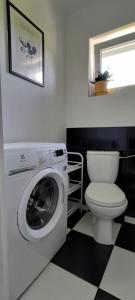 a bathroom with a washing machine and a toilet at Konstancin Comfort - Twój Dom z Daleka od Domu in Konstancin-Jeziorna +26 photos