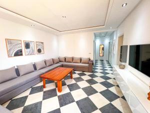 a living room with a couch and a table at Visit Chamal - Florencia in Oued Laou