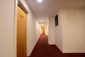 a hallway with a hallway leading to a room with a door at Apartment In Manchester City in Manchester