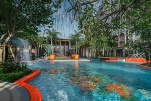 a swimming pool with a fountain in a building at Pool Access La Habana HuaHin Managed By Asiabb in Hua Hin