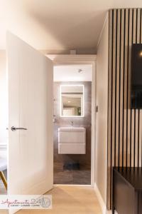 a bathroom with a sink and a mirror at Beautiful Studio Apartment - London in Hounslow