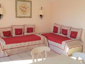 a room with two beds and a table and chairs at Maison Duplex 8 Pers avec Terrasse, 3 Ch, Parking Gratuit, Animaux Admis, Accès Piscine - FR-1-382-128 in Grospierres +6 photos