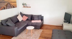 a living room with a couch and a table at Appartement - FeWo Wenne in Langenau