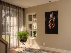 a room with a window and a painting on the wall at Holiday Home Het Landhuis by Interhome in Losser
