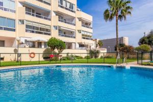 a swimming pool in front of a building at Vistamarina B308 By IVI Real Estate in Torremolinos