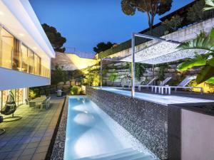 a swimming pool in the backyard of a house at Holiday Home Nathalie by Interhome in Sant Antoni de Calonge