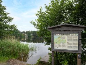 a sign in front of a body of water at Holiday Home Solbacken by Interhome in Alingsås