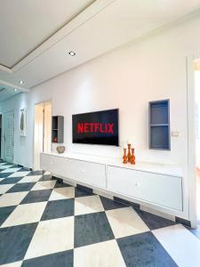 a living room with a television on a wall at Visit Oued Laou - Florencia in Oued Laou