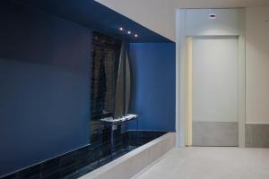 een badkamer met een blauwe muur en een spiegel bij Hotel Velino in Avezzano +24 foto's