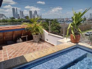 a swimming pool on the roof of a building with plants at Casa Marqués del Pedregal in Cartagena de Indias