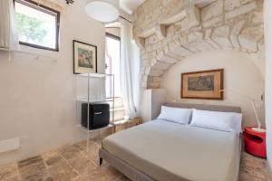 Postel nebo postele na pokoji v ubytování Il Sogno delle Benedettine