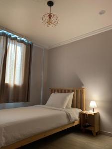 a bedroom with a bed and a window at Hostel Espace in Chuncheon