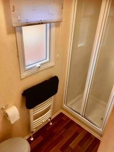 a bathroom with a shower and a window and a towel at Park Gate, Colyton, farm,near beaches-‘Annie’ in Colyton