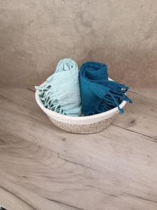 a basket filled with clothes sitting on a wooden floor at House Of Diamond in Kírra