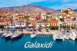 a view of a harbor in a town with boats in the water at House Of Diamond in Kírra
