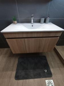 a bathroom with a white sink and a rug at House Of Diamond in Kírra +41 photos