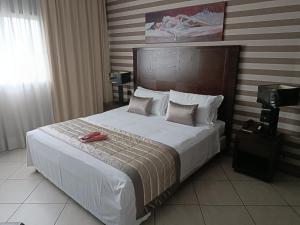 Postel nebo postele na pokoji v ubytování Green Hotel Ninfa