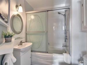 a bathroom with a shower and a sink at Bright Condo near the Lake by GLOBALSTAY in Mont-Tremblant +14 photos