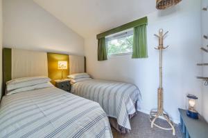 a bedroom with two beds and a window at The Billy Shed in Bridport