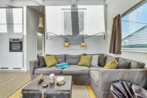 a living room with a couch and a table at The Billy Shed in Bridport