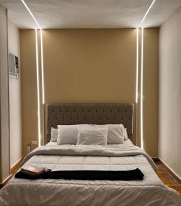 a bedroom with a large bed with lights on it at lovely apartment in Zamalek in Cairo