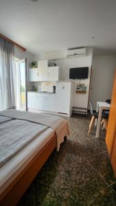 a bedroom with a bed and a table and a tv at Villa Darinka in Fažana