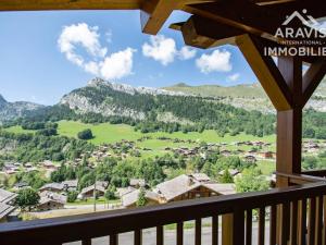 a view from a balcony of a village with mountains at Appartement Le Grand-Bornand, 3 pièces, 7 personnes - FR-1-391-97 in Le Grand-Bornand