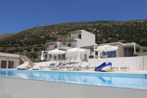 a hotel with a swimming pool in front of a building at Diamond Star Hotel in Falasarna