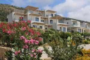 a large building with flowers in front of it at Diamond Star Hotel in Falasarna