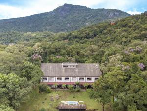 an aerial view of a house in the middle of a mountain at Pousada VillaSerrana in Monte Verde