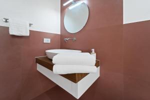 a bathroom with a white sink and a mirror at Paquja in Quartu SantʼElena