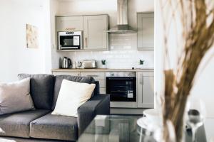 a living room with a couch and a kitchen at Hideaway by Liv Retreats in Lincoln +68 photos