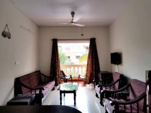 a living room with couches and a table and a window at #vrabode 1BHK apartment w Pool at Seacoast Retreat Varca in Talaulim