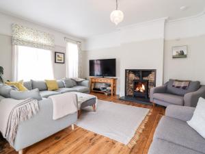 a living room with a couch and a fireplace at 16 Garfield Road in Felixstowe