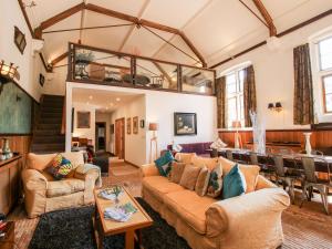 a living room with a couch and a table at Talbot Lodge in Stafford