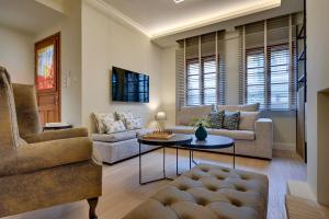 a living room with a couch and a table at Harmony villa - Ioannina castle in Ioannina