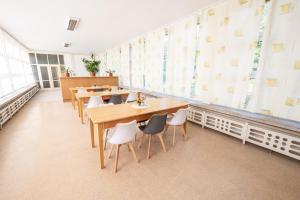 a restaurant with tables and chairs in a room at Lázně Meziboří in Meziboři