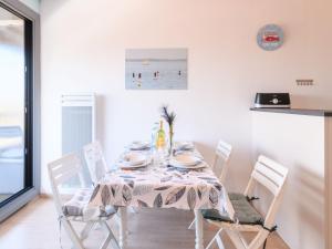 une salle à manger avec une table et des chaises blanches dans l'établissement Studio Les Gabiers by Interhome, à Arcachon