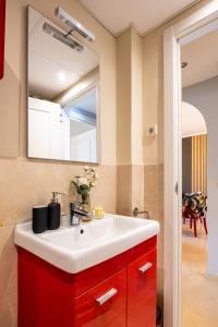 ein Badezimmer mit einem roten Waschbecken und einem Spiegel in der Unterkunft Maravilloso Apartamento en Mijas Golf in Mijas