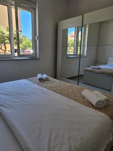 Postel nebo postele na pokoji v ubytování Apartmani Vuković
