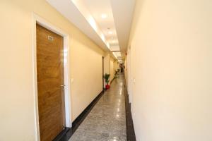 a hallway with a wooden door in a building at FabHotel GK Residency in New Delhi