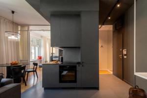 a kitchen with gray cabinets and a table in a room at apartamenty-wroc Księcia Witolda by the River in Wrocław