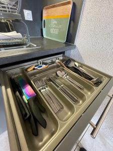 a drawer in a kitchen with some knives and utensils at Au Doubs Village in Métabief
