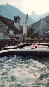 a pool of water in front of a house at La Baita Contemporanea; mix tra passato e presente in Prato