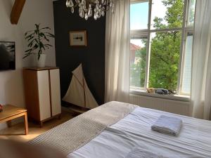 a bedroom with a bed and a large window at Stensö Room in Kalmar