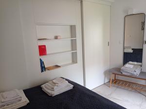 a bedroom with a bed and a mirror at Heritage 4-Stars Apartment Kyra Pitve Hvar in Jelsa