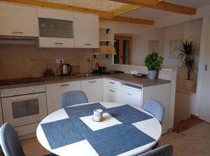 a kitchen with a table and chairs in a room at Heritage 4-Stars Apartment Kyra Pitve Hvar in Jelsa