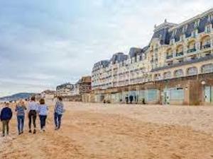 a group of people walking on the beach at Appartement Cabourg, 2 pièces, 4 personnes - FR-1-465-61 in Cabourg
