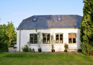 una casa bianca con delle piante davanti di Landhaus von 1836 im Naturpark Schlei a Twedt