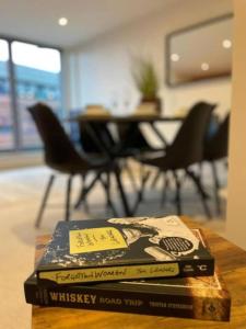 a stack of three books sitting on a table at Paramount city living 105 in Swindon